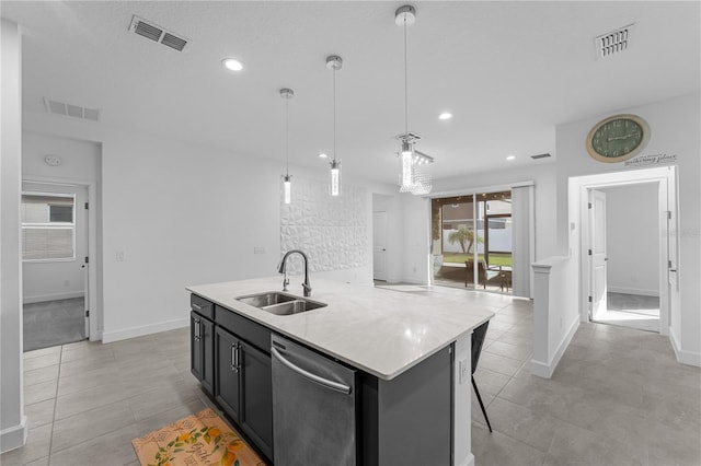 kitchen featuring a breakfast bar area, hanging light fixtures, an island with sink, sink, and stainless steel dishwasher