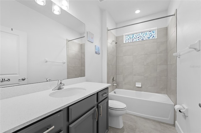 full bathroom featuring toilet, vanity, tile patterned flooring, and tiled shower / bath combo