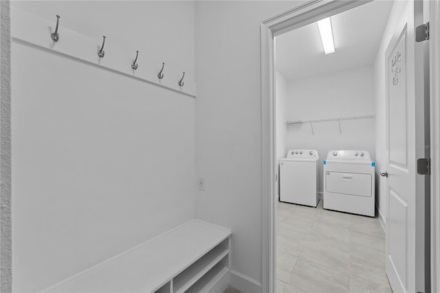 mudroom with washing machine and dryer and light tile patterned floors