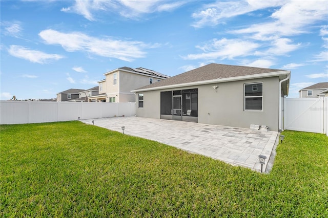 rear view of property with a patio area and a yard