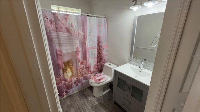 full bath with curtained shower, vanity, toilet, and wood finished floors