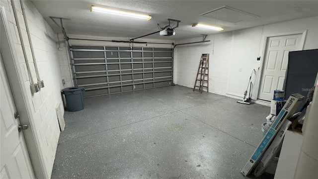 garage with concrete block wall and a garage door opener