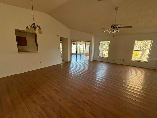 interior space with lofted ceiling, ceiling fan with notable chandelier, and wood-type flooring