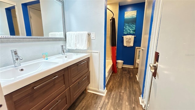 full bathroom featuring toilet, shower / tub combo, vanity, and hardwood / wood-style flooring