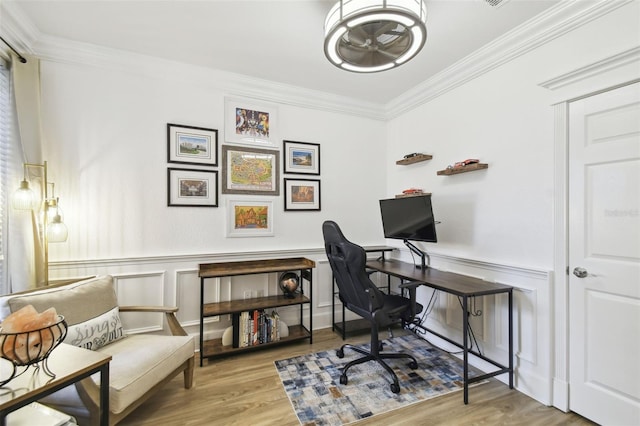 home office featuring crown molding and light hardwood / wood-style flooring