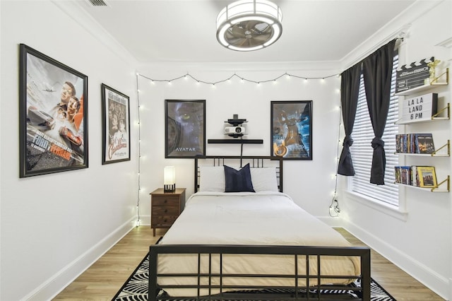 bedroom featuring hardwood / wood-style flooring and ornamental molding