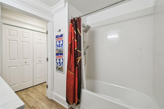 bathroom featuring crown molding, shower / bath combination with curtain, and wood-type flooring