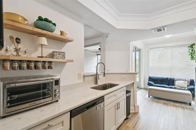 kitchen with dishwasher, sink, crown molding, white cabinetry, and light stone countertops