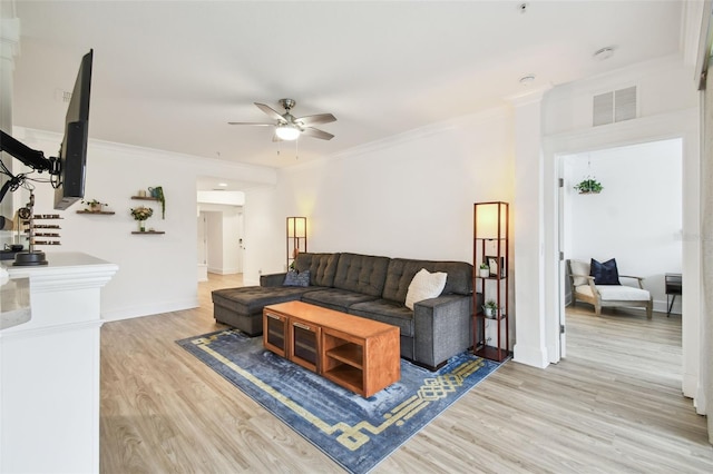 living room featuring light hardwood / wood-style floors, crown molding, and ceiling fan