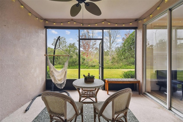 sunroom featuring ceiling fan and a wealth of natural light