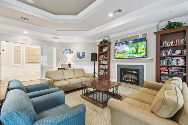 living room featuring ornamental molding and a raised ceiling