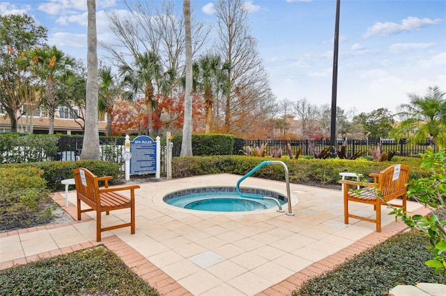 view of pool featuring a hot tub and a patio area