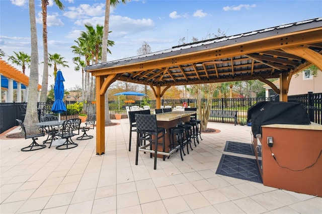 view of patio featuring area for grilling and a bar