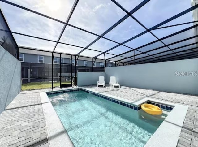 view of pool featuring a lanai and a patio area