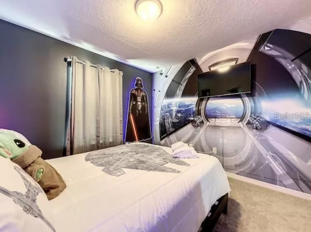 carpeted bedroom with a textured ceiling