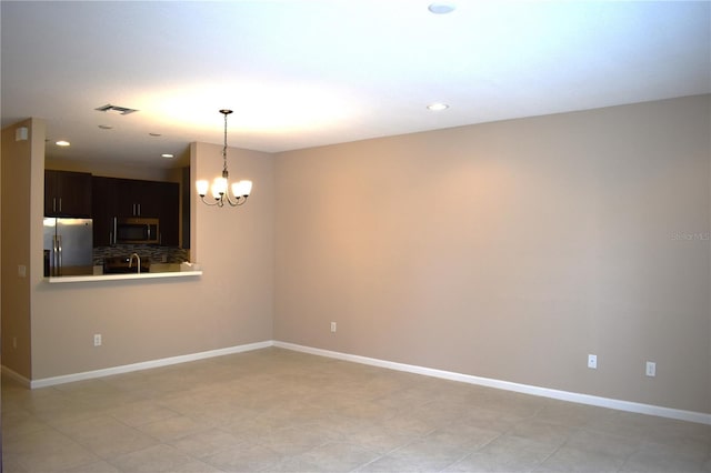 empty room featuring a chandelier