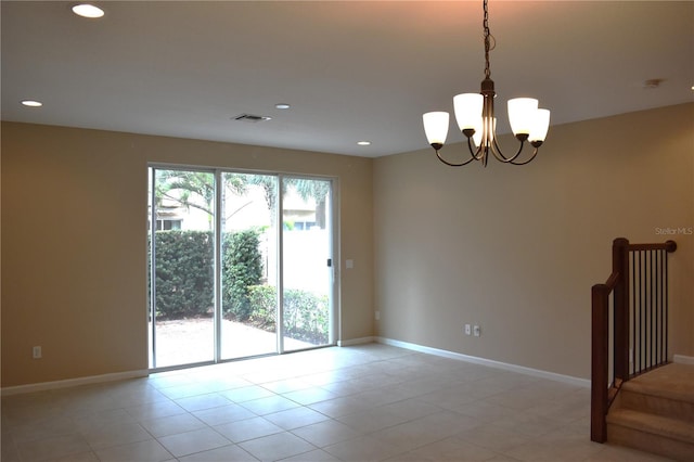 empty room with a notable chandelier and light tile patterned flooring