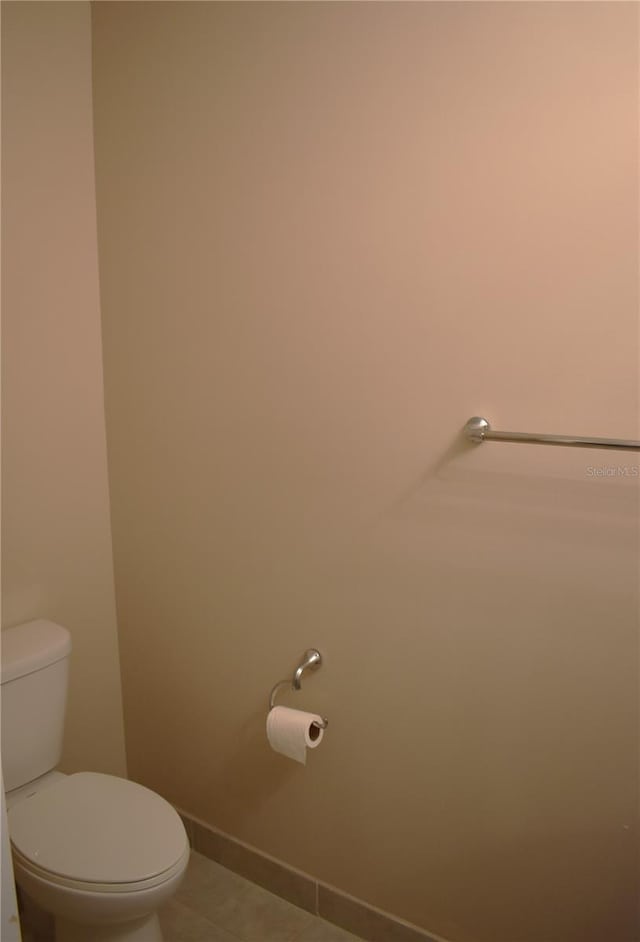 bathroom featuring toilet and tile patterned flooring