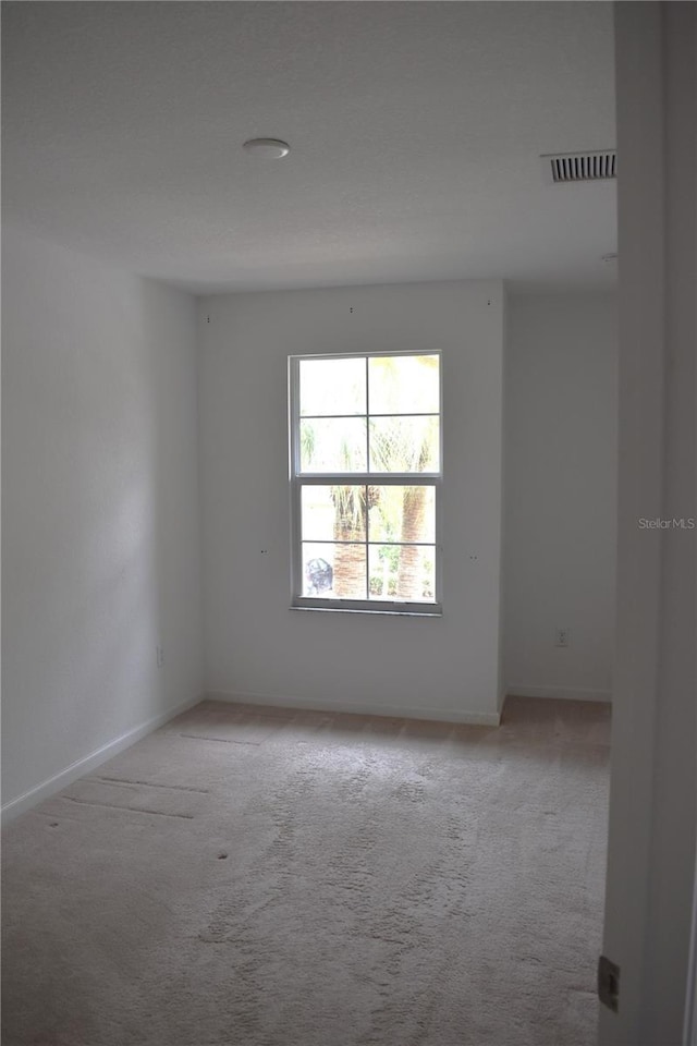 empty room with light colored carpet