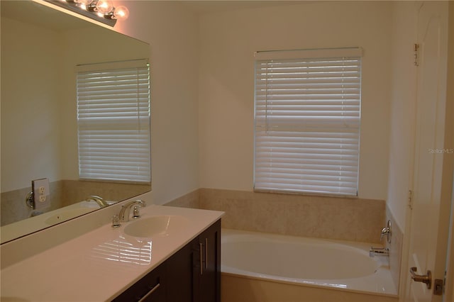 bathroom featuring vanity and a bath