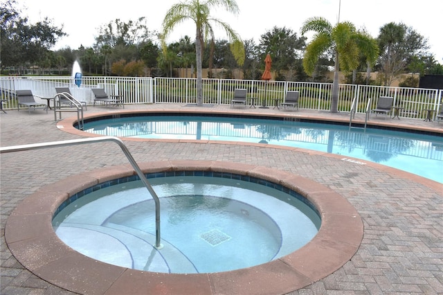 view of pool with a community hot tub and a patio