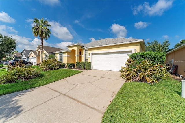 view of front of property featuring a front yard and a garage