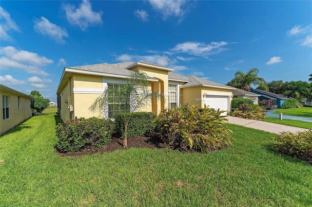 view of front of property featuring a garage and a front lawn