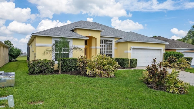 view of front of home with a front lawn and a garage