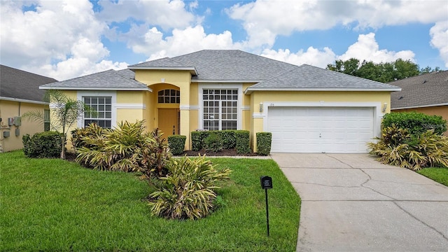 view of front of home with a front lawn and a garage