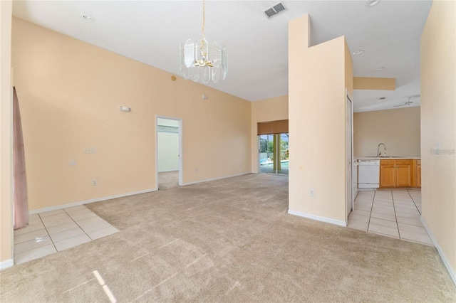 unfurnished room featuring a notable chandelier, light tile patterned flooring, and sink