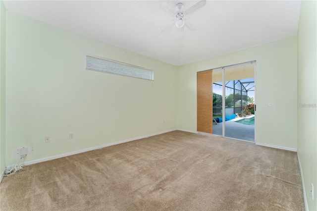 carpeted spare room featuring ceiling fan