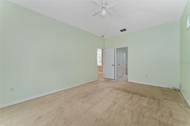 carpeted empty room with ceiling fan and a tray ceiling