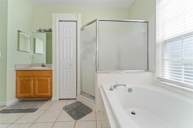 bathroom with tile patterned flooring, independent shower and bath, and vanity