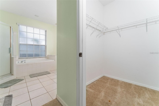 spacious closet featuring light tile patterned floors