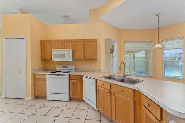 kitchen featuring white appliances, kitchen peninsula, sink, decorative light fixtures, and light tile patterned flooring