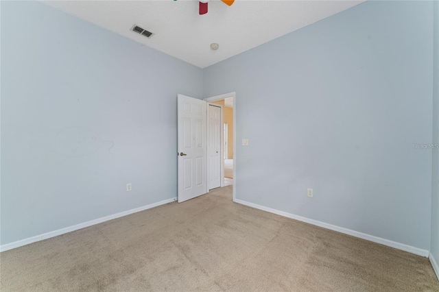 unfurnished room with ceiling fan and light colored carpet