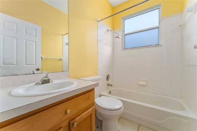 full bathroom featuring tiled shower / bath, tile patterned flooring, vanity, and toilet