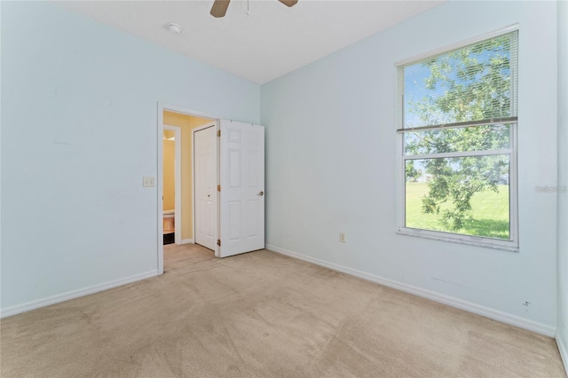 unfurnished bedroom with light carpet and ceiling fan