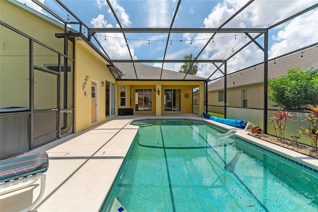 view of swimming pool with a patio and glass enclosure