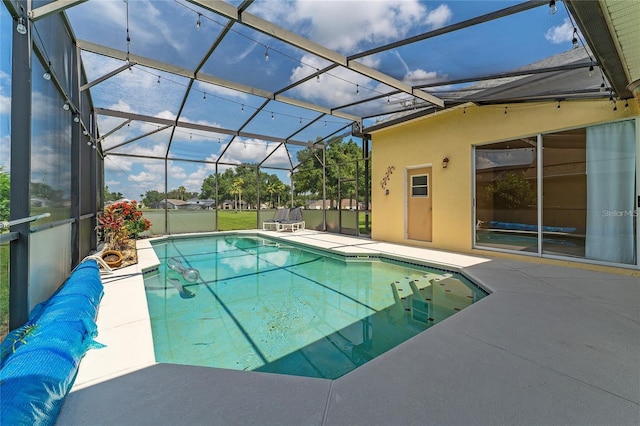 view of pool featuring a patio area and glass enclosure