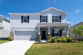 view of front of house with a front yard and a garage