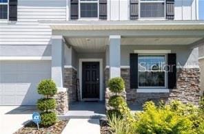 view of exterior entry with a garage