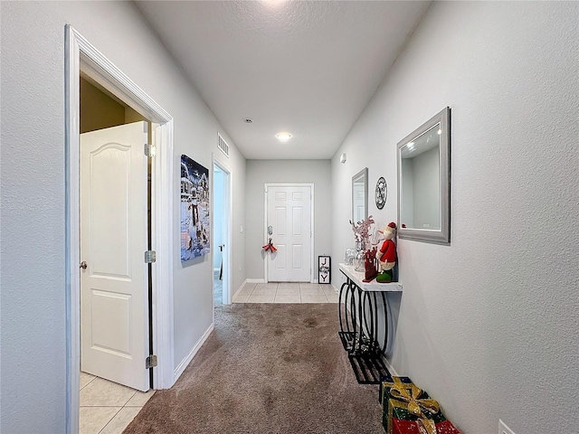 hall featuring light colored carpet