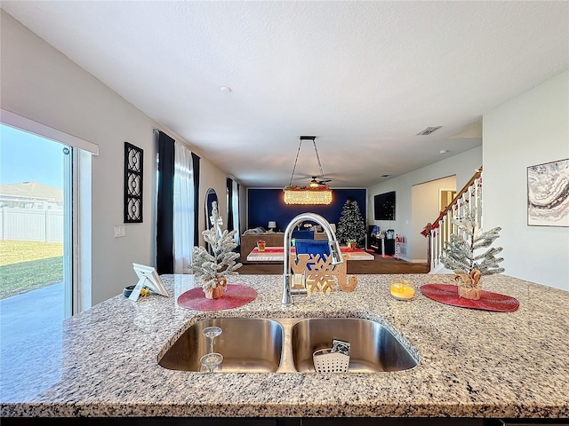 kitchen with sink and light stone counters