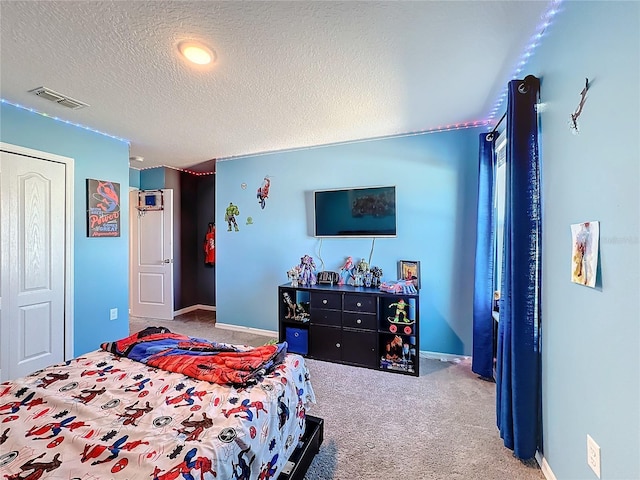 carpeted bedroom featuring a textured ceiling