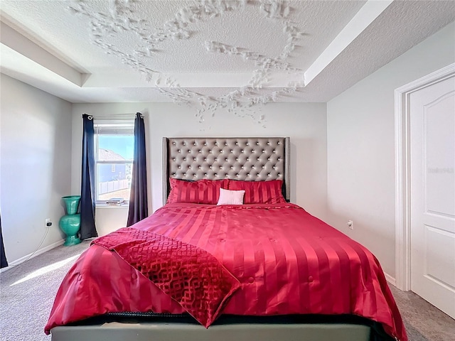 bedroom featuring carpet and a textured ceiling