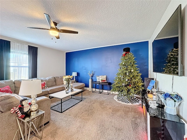 carpeted living room featuring ceiling fan and a textured ceiling