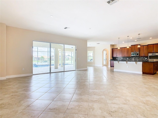 unfurnished living room featuring light tile patterned flooring