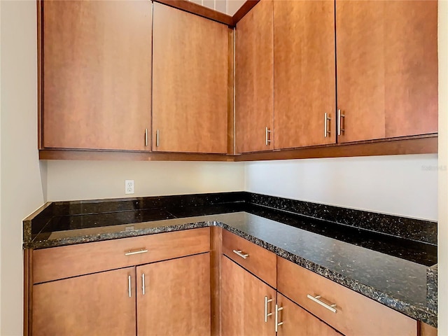 kitchen featuring dark stone countertops