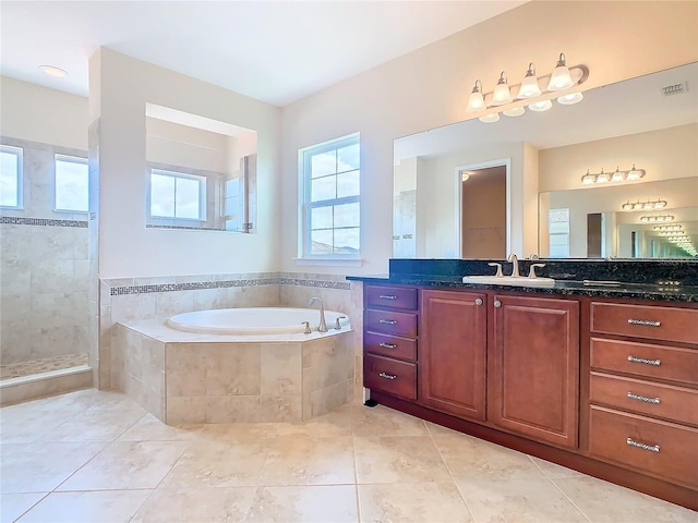 bathroom with tile patterned floors, vanity, and separate shower and tub